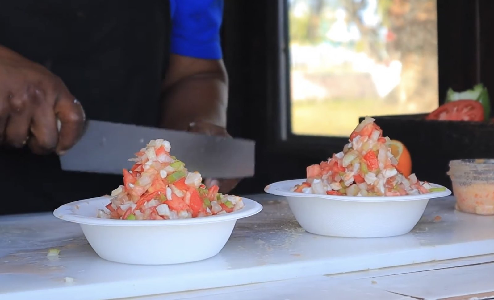 Fresh conch salad being prepared and served in bowls